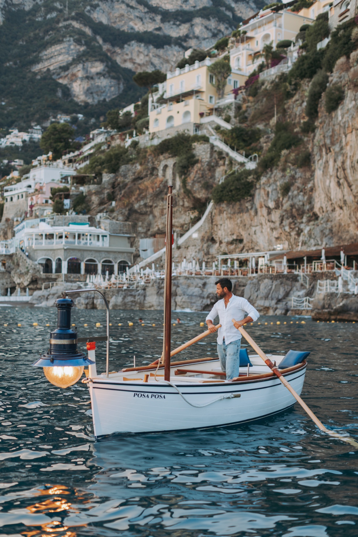 Traditional boatman rowing Posa Posa along Positano