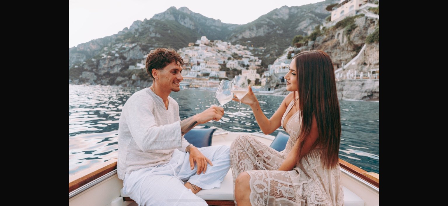 Couple enjoying a romantic traditional boat experience in Positano